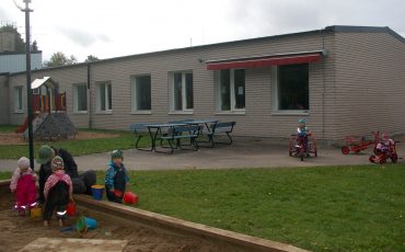 BIld på förskolan i Älmestad som är en vit tegelbyggnad med röd markis.